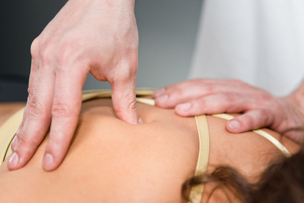 woman getting her upper back pain treated